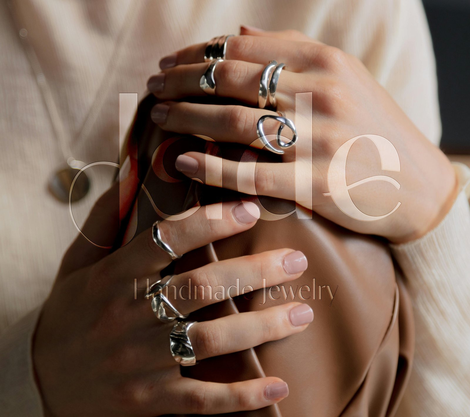 Feminine jewelry logo design for Jade, a handmade jewelry brand, featuring soft curves inspired by ring shapes and the natural lines of women’s bodies, expressing craftsmanship, elegance, and empowerment.