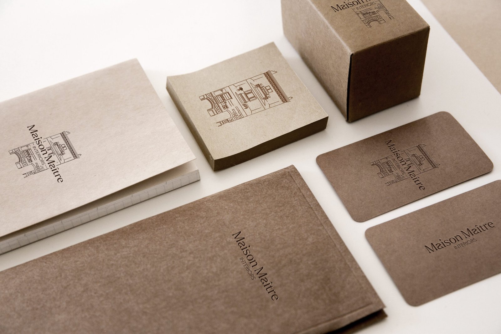 Luxury interior design logo for Maison Maître featuring a minimalist maison de maître illustration and custom-designed typography, created for a refined and timeless brand identity.