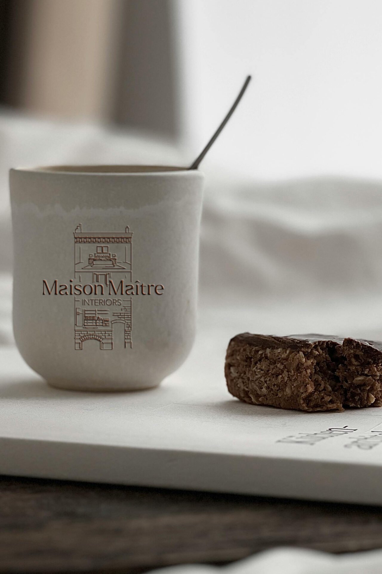 Luxury interior design logo for Maison Maître featuring a minimalist maison de maître illustration and custom-designed typography, created for a refined and timeless brand identity.