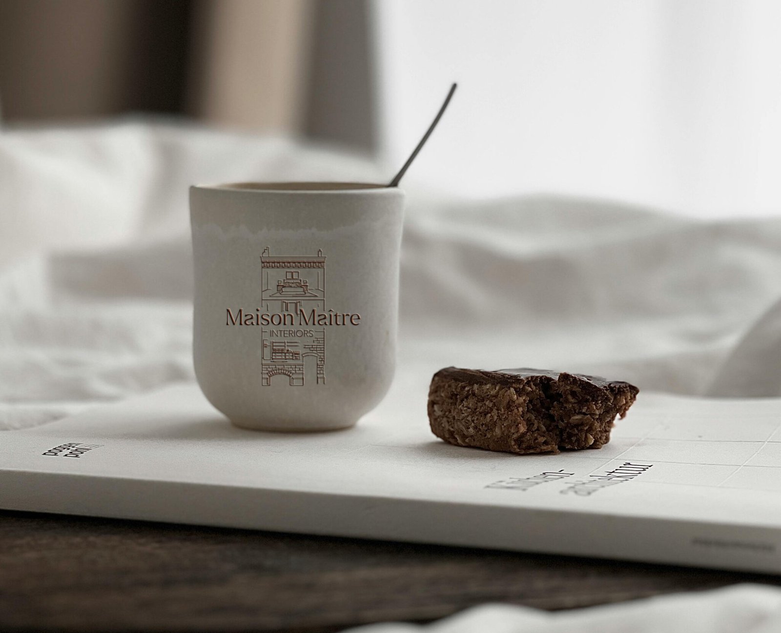 Luxury interior design logo for Maison Maître featuring a minimalist maison de maître illustration and custom-designed typography, created for a refined and timeless brand identity.