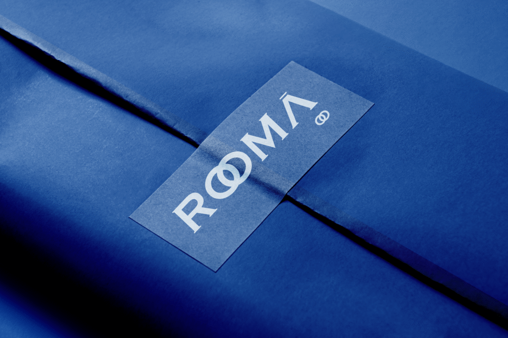 Italian clothing brand logo for Rooma featuring custom typography inspired by Roman architecture and timeless Italian craftsmanship, designed for a refined and contemporary fashion identity.