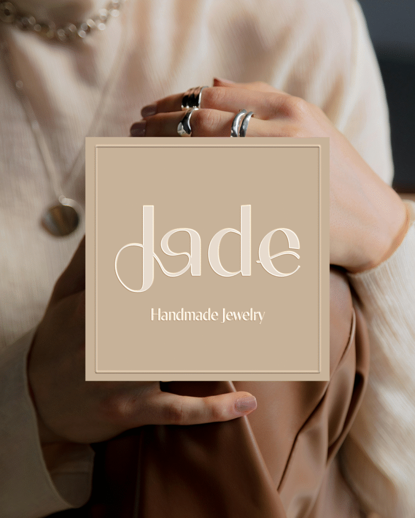 Feminine jewelry logo design for Jade, a handmade jewelry brand, featuring soft curves inspired by ring shapes and the natural lines of women’s bodies, expressing craftsmanship, elegance, and empowerment.
